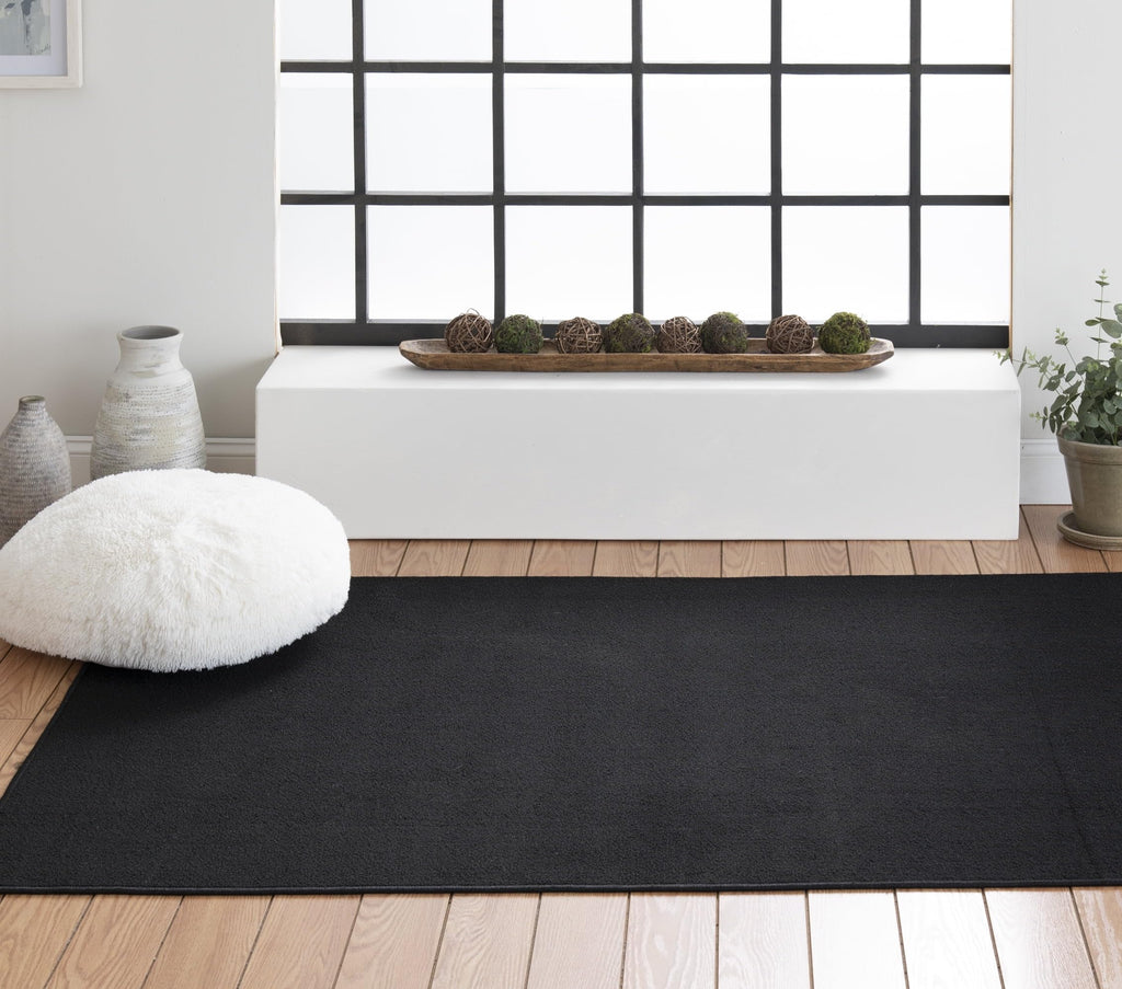 Solid Black Indoor Area Rug, 54"×78" Stain Fade Resistant Woven Carpet, Pet Friendly For Garage Basement Living Room Dining product image